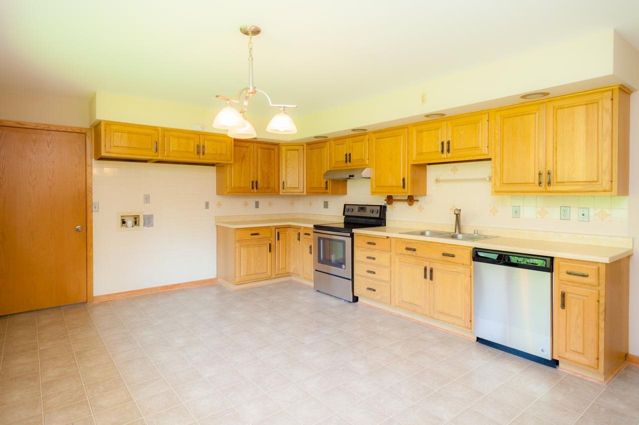 18660 Burr Oak Road Capron, IL 61012 - Photo 9 of 25 a kitchen with cabinets a sink and white appliances
