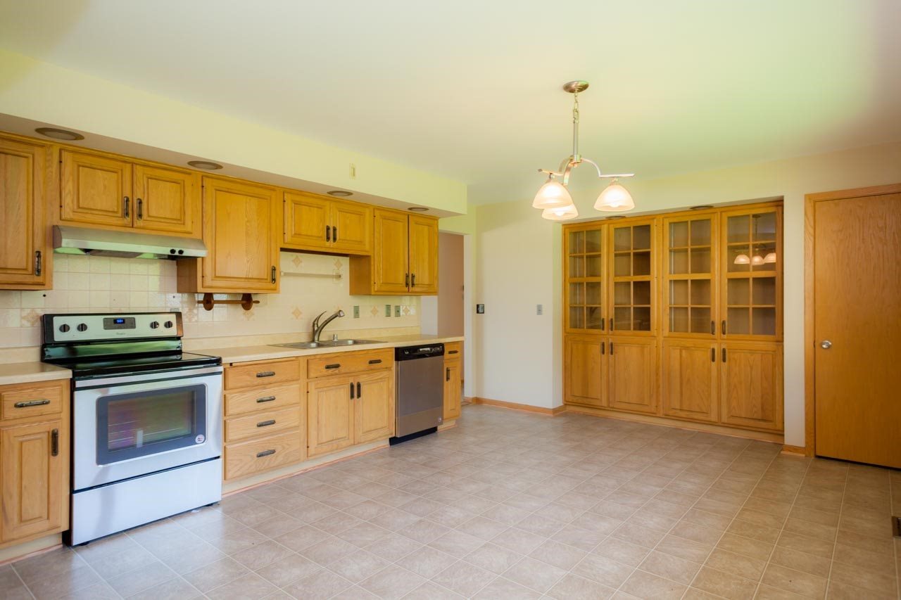 18660 Burr Oak Road Capron, IL 61012 - Photo 10 of 25 a kitchen with granite countertop a stove sink and cabinets