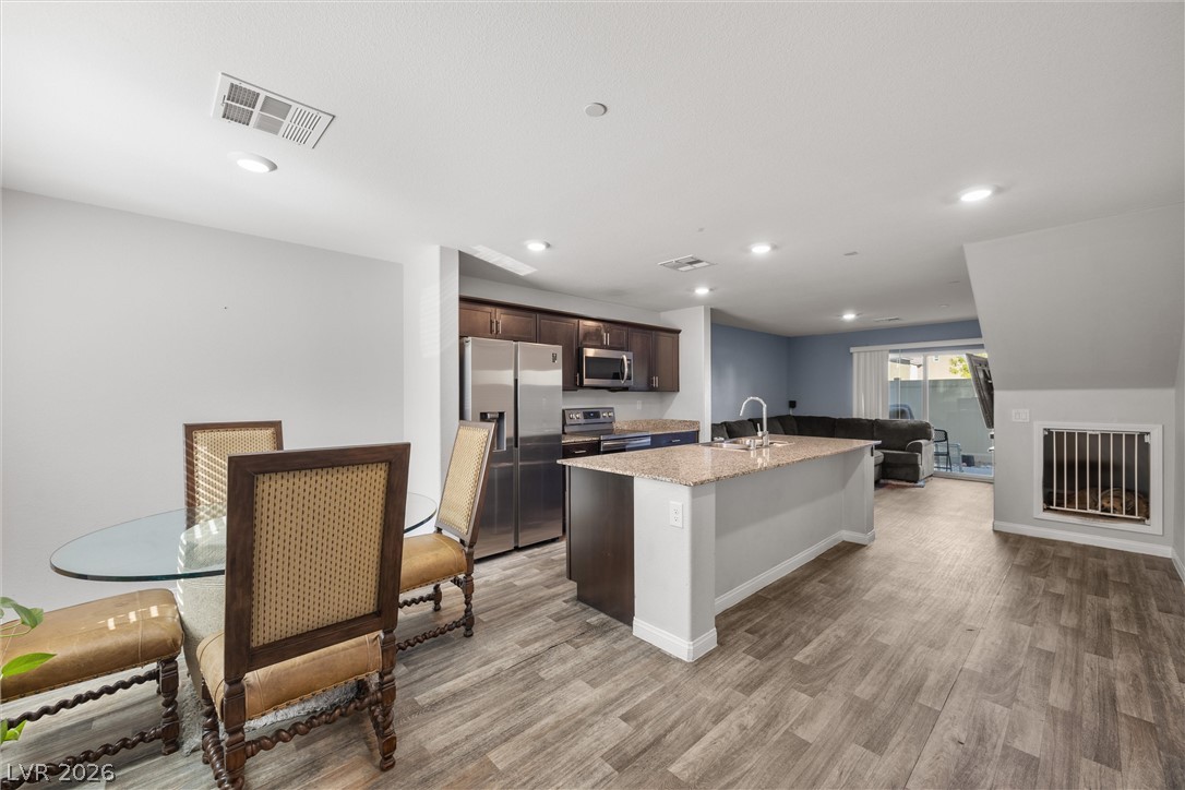 12240 Golden Wreath Road, Unit 2 Las Vegas, NV 89183 - Photo 28 of 29 An open floorplan seamlessly connects the kitchen and dining area to the main living space.