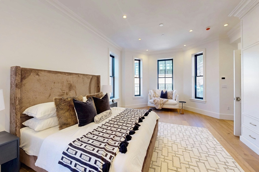 57 Hancock Street Boston, MA 02114 - Photo 23 of 42 a bedroom with a large bed and a couch