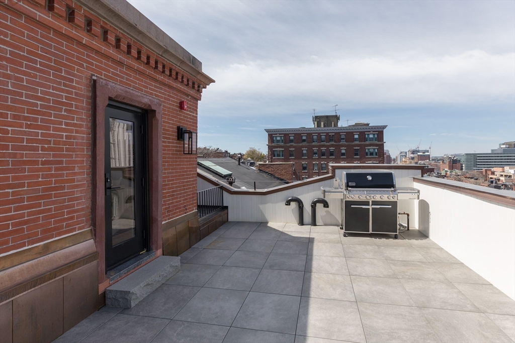 57 Hancock Street Boston, MA 02114 - Photo 38 of 42 a kitchen with a stove top oven and cabinets