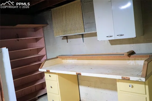 a view of a room with a table and chairs