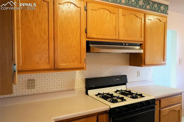 a kitchen with a stove a sink and a microwave