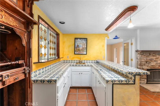 a bathroom with a granite countertop sink and a large mirror