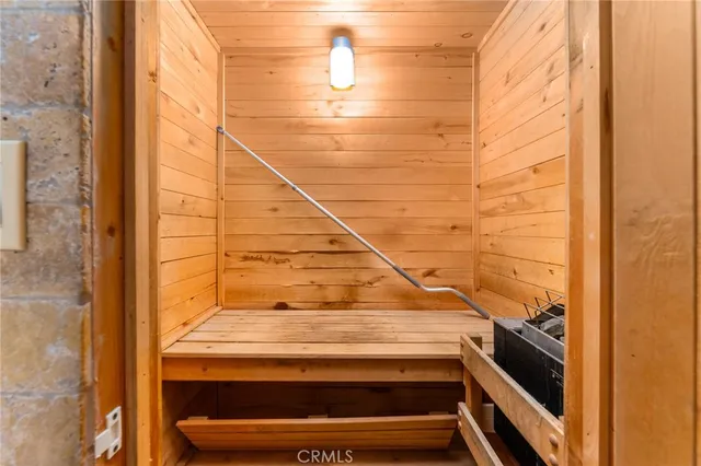 a view of a big room with wooden floor and windows