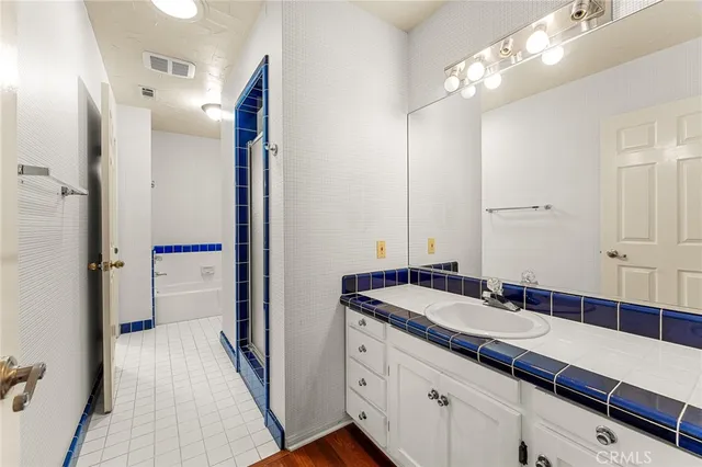 a view of a house with a big yard and large trees