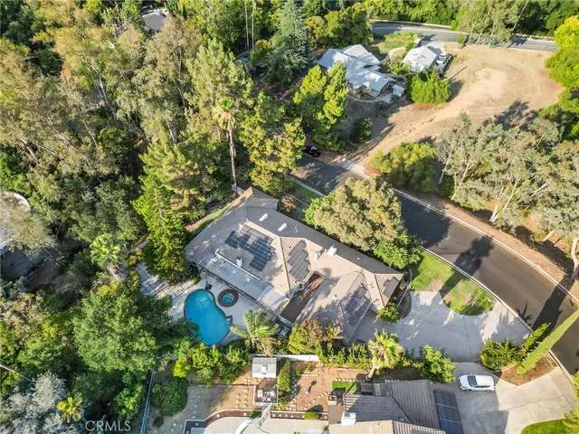 a view of a house with swimming pool and sitting area