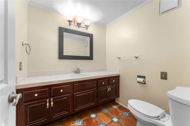 a bathroom with a toilet a sink and mirror