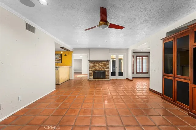a view of empty room with wooden floor and fireplace