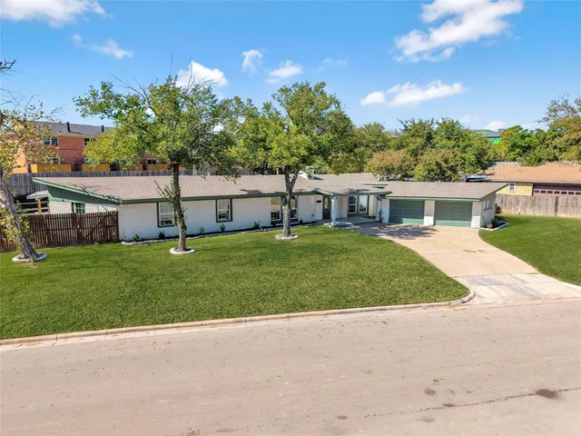 a house view with a sitting space and garden