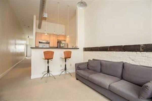 296 Meridian Street, Unit 1 Boston, MA 02128 - Photo 2 of 9 a living room with furniture and a kitchen view