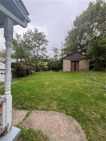 a view of a house with a yard and sitting area
