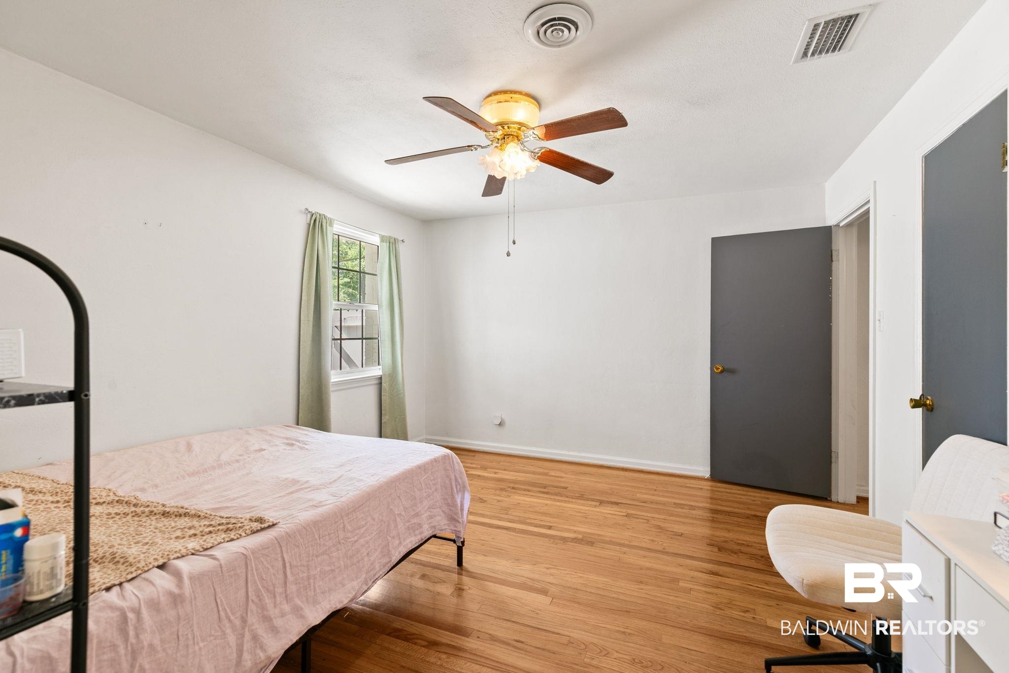 927 Cleveland Road Saraland, AL 36571 - Photo 27 of 80 Room featuring wood-finish flooring, a ceiling fan with integrated lighting, and a window with natural light