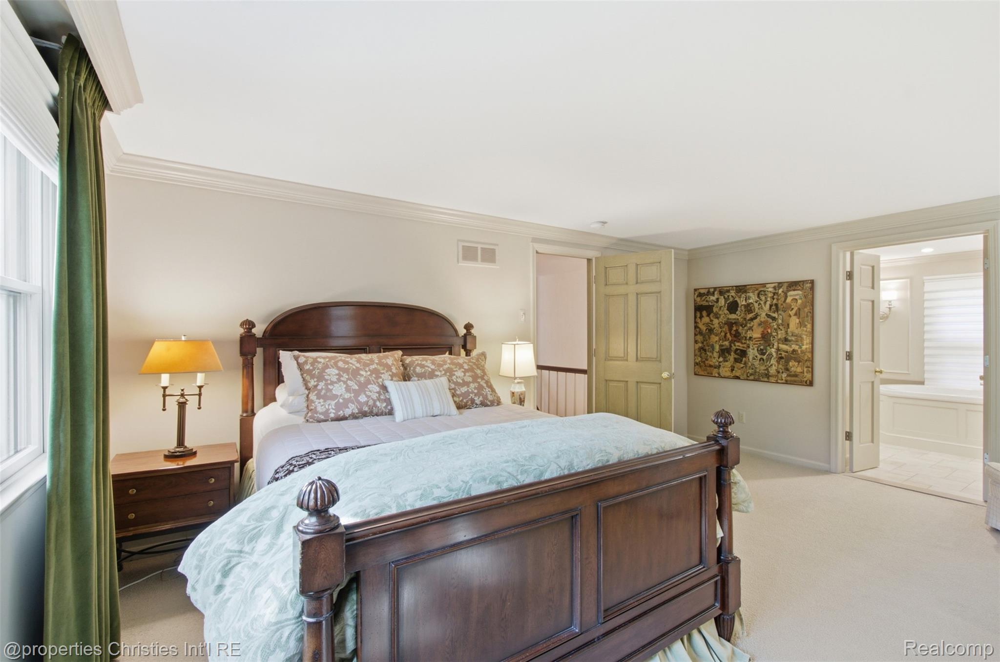 25235 Canterbury Road Franklin, MI 48025 - Photo 27 of 56 Carpeted room with a dark wood bed frame, white walls, and crown molding