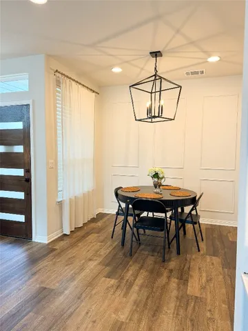 a view of a dining room with furniture window and wooden floor