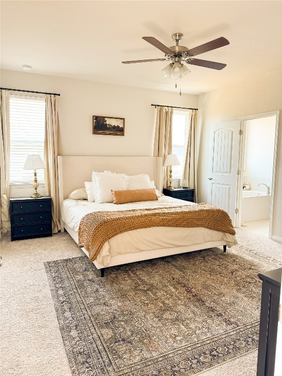 144 Alexander Kyle, TX 78640 - Photo 7 of 11 a bedroom with a large bed and a chandelier