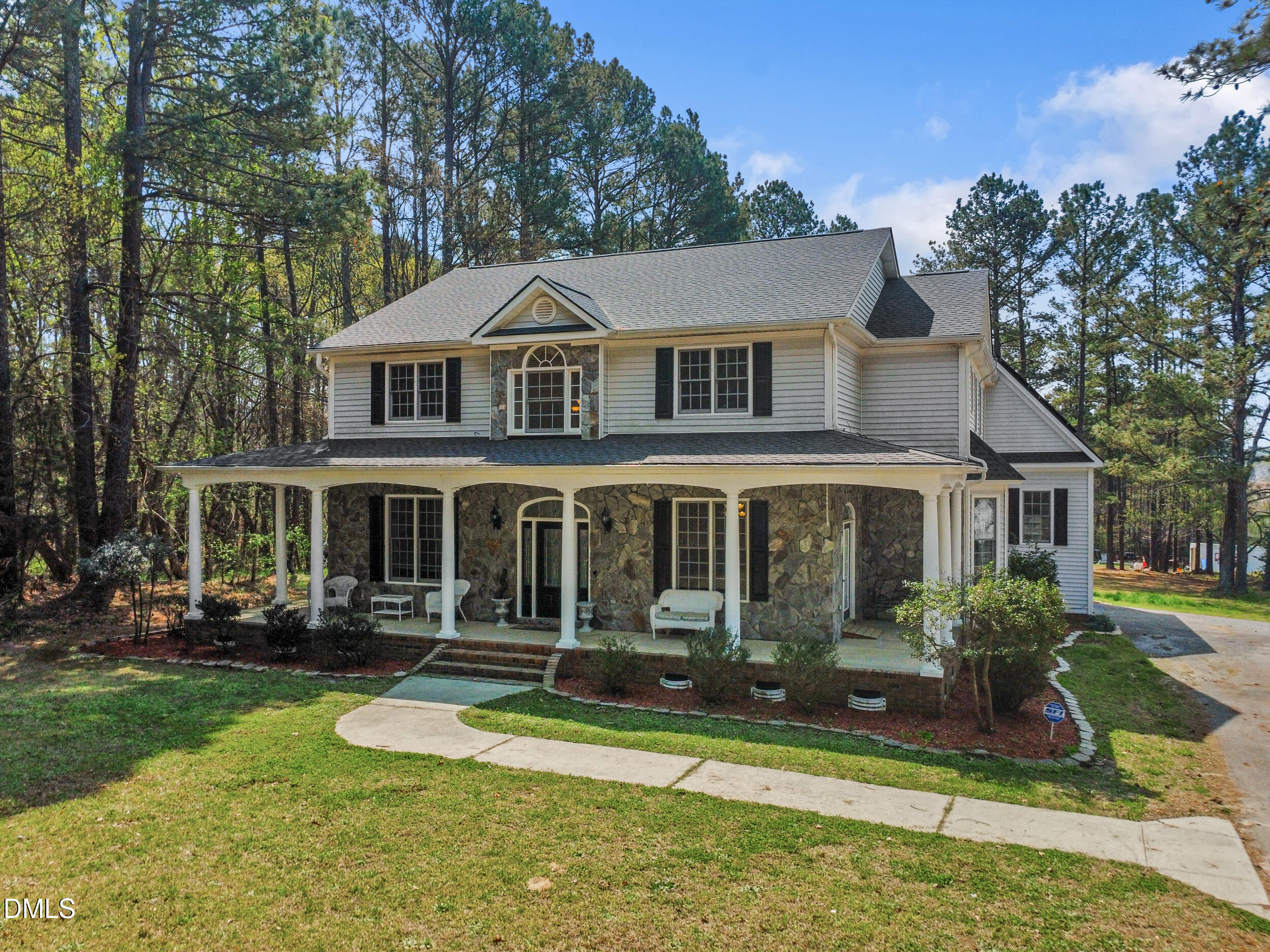 a front view of a house with a yard table and chairs