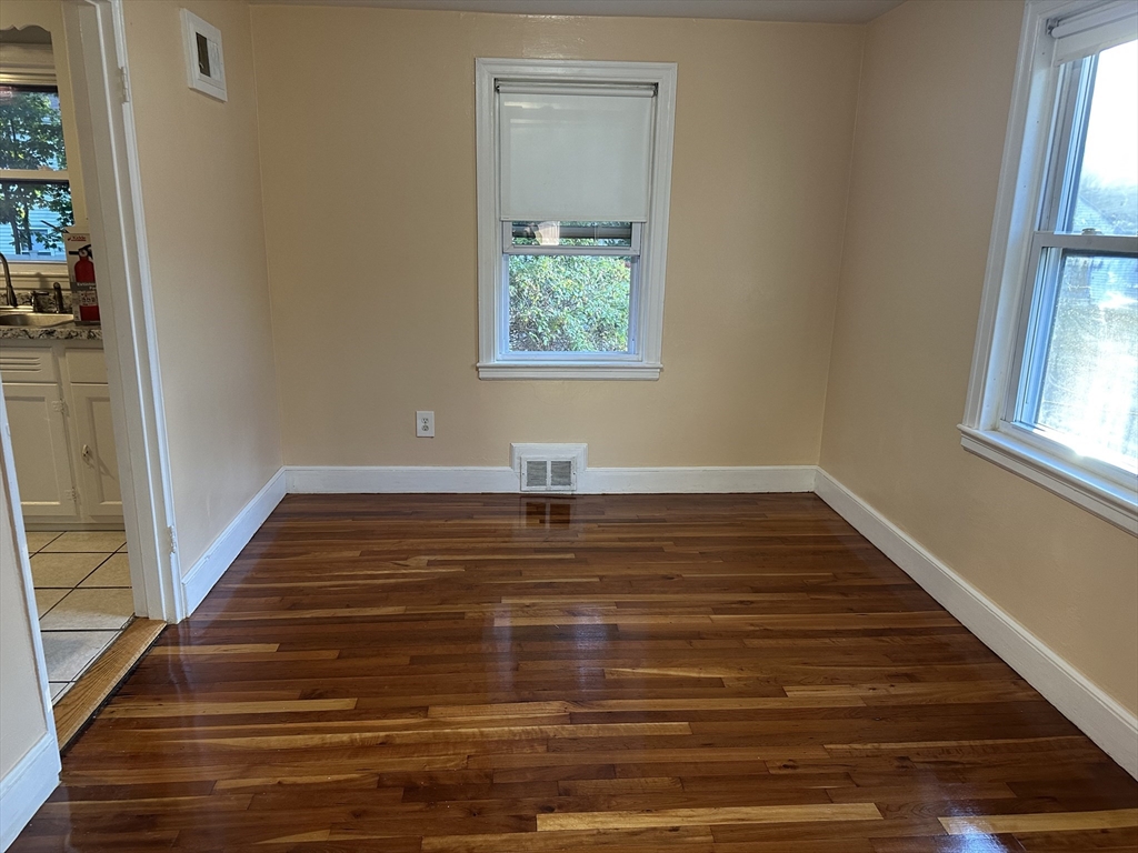 3 Arborcrest Terrace, Unit 2 Boston, MA 02126 - Photo 11 of 29 a view of an empty room with wooden floor and a window