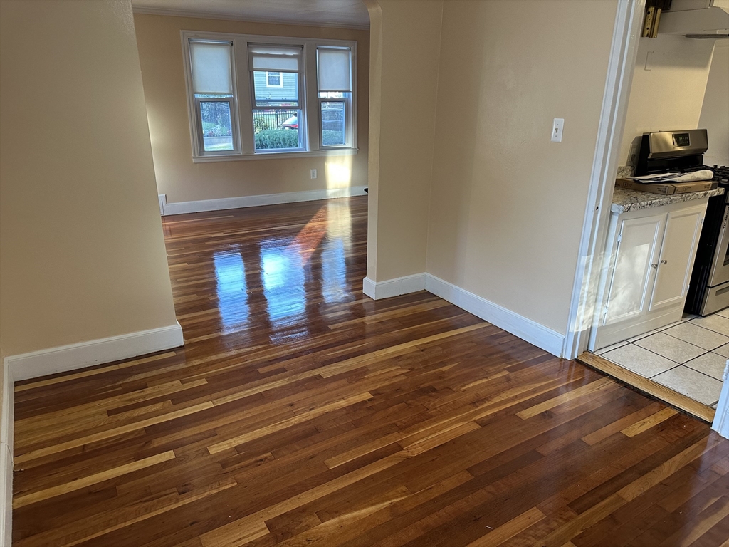 3 Arborcrest Terrace, Unit 2 Boston, MA 02126 - Photo 12 of 29 a view of an empty room with wooden floor and a window