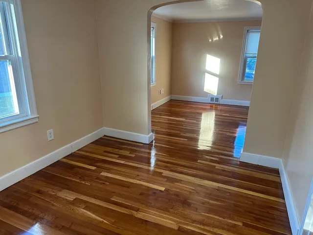 a view of wooden floor and windows in a room