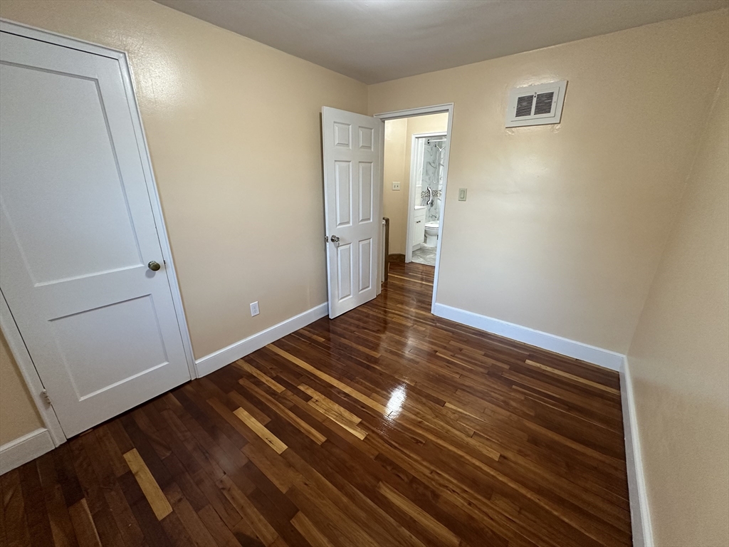 3 Arborcrest Terrace, Unit 2 Boston, MA 02126 - Photo 22 of 29 a view of an empty room and wooden floor