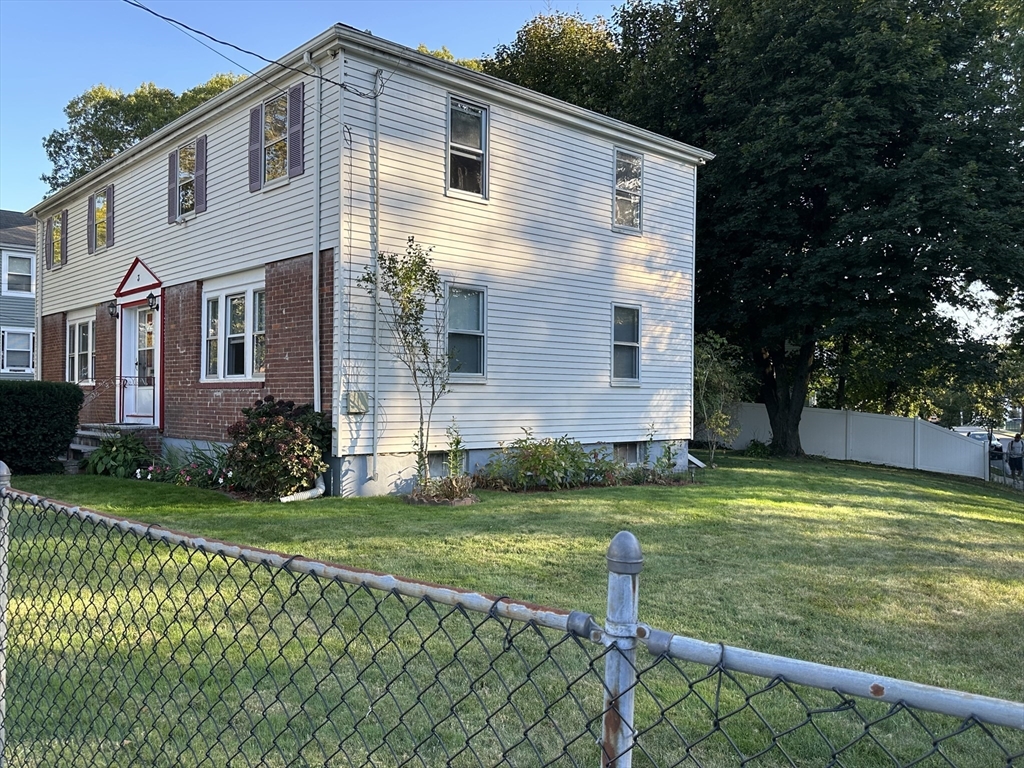 3 Arborcrest Terrace, Unit 2 Boston, MA 02126 - Photo 3 of 29 a front view of a house with a yard