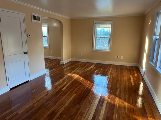 a view of a room with wooden floor and workspace