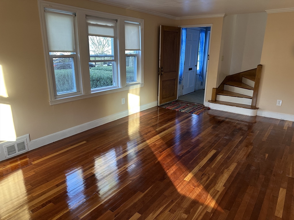 3 Arborcrest Terrace, Unit 2 Boston, MA 02126 - Photo 8 of 29 a room with wooden floor and windows