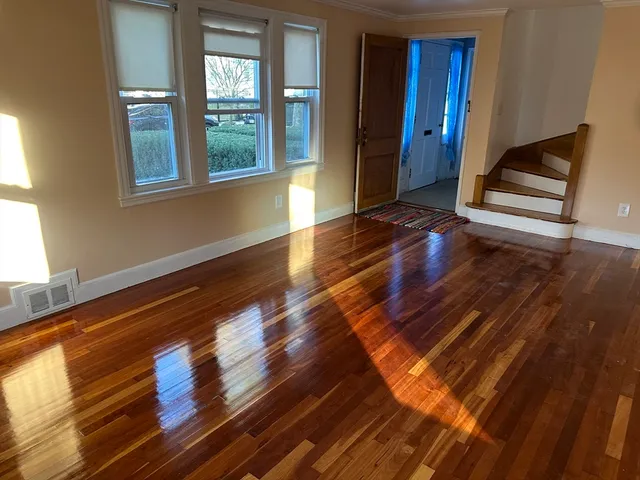 a view of wooden floor and windows in a room