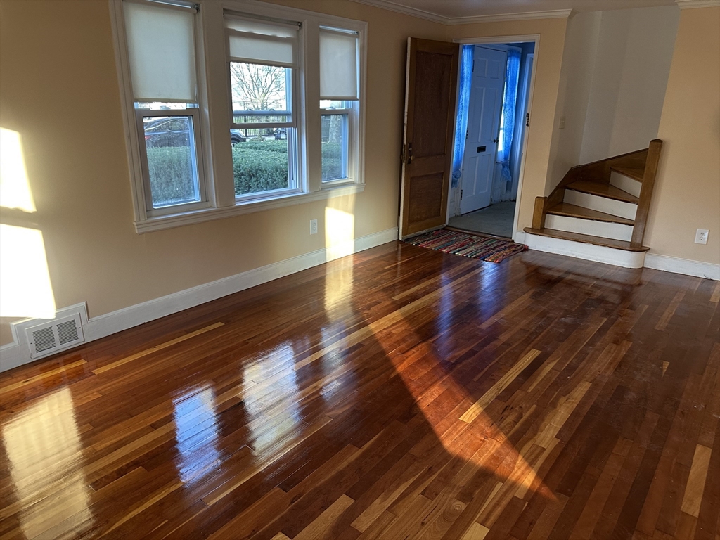 3 Arborcrest Terrace, Unit 2 Boston, MA 02126 - Photo 9 of 29 a view of wooden floor and windows in a room