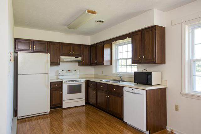 2408 River Road New Market, VA 22844 - Photo 4 of 16 a kitchen with a sink a refrigerator a window and cabinets