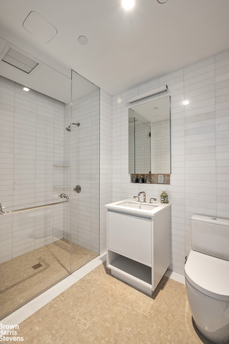 1289 Lexington Avenue, Unit 11D Manhattan, NY 10028 - Photo 10 of 16 a bathroom with a sink a toilet and shower