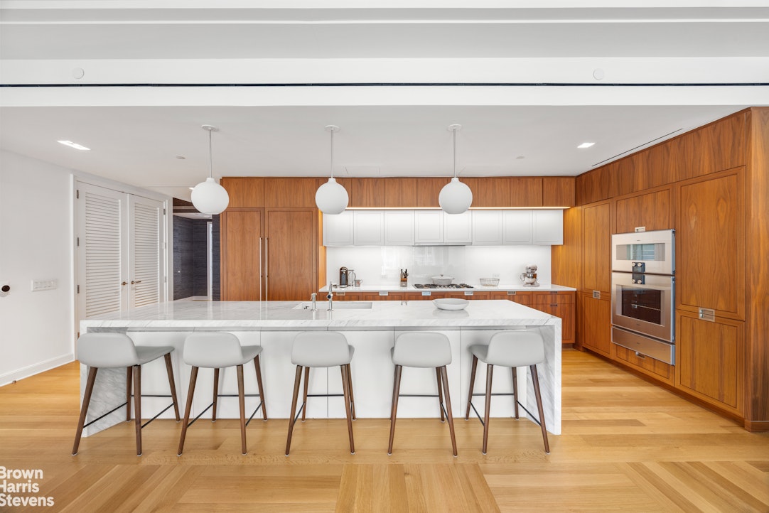 1289 Lexington Avenue, Unit 11D Manhattan, NY 10028 - Photo 3 of 16 a kitchen with a table and chairs in it