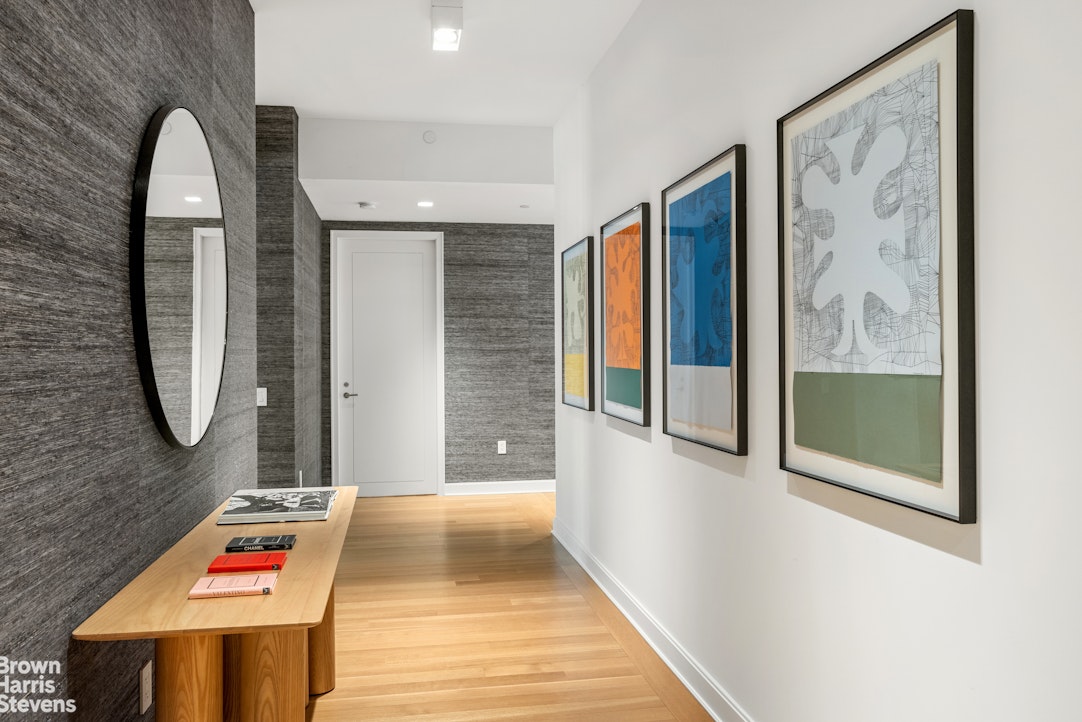 1289 Lexington Avenue, Unit 11D Manhattan, NY 10028 - Photo 4 of 16 a view of a hallway with wooden floor and furniture