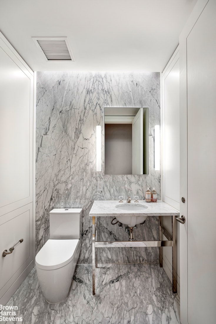 1289 Lexington Avenue, Unit 11D Manhattan, NY 10028 - Photo 5 of 16 a bathroom with a toilet sink and mirror