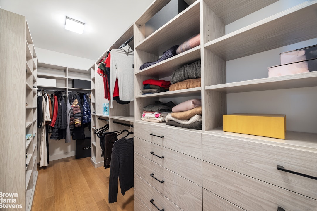 1289 Lexington Avenue, Unit 11D Manhattan, NY 10028 - Photo 7 of 16 a view of walk in closet with clothes and shoes