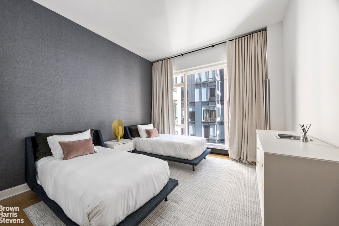 1289 Lexington Avenue, Unit 11D Manhattan, NY 10028 - Photo 9 of 16 a bedroom with two beds and large window