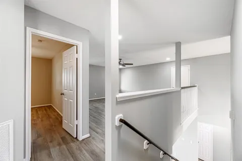 a view of walk in closet with wooden floor