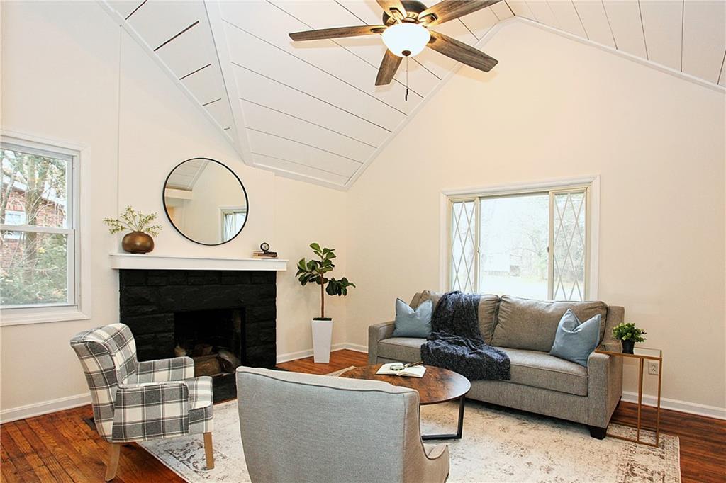 46 Michael Road Russellton, PA 15076 - Photo 7 of 25 a living room with furniture a fireplace a flat screen tv and a window