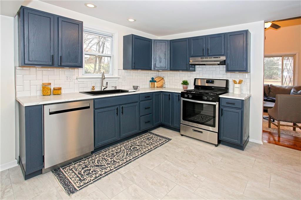 46 Michael Road Russellton, PA 15076 - Photo 9 of 25 a kitchen with stainless steel appliances granite countertop a stove top oven a sink dishwasher and a refrigerator with wooden cabinets