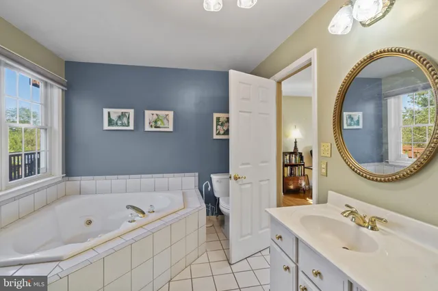 a bathroom with a tub sink and a window