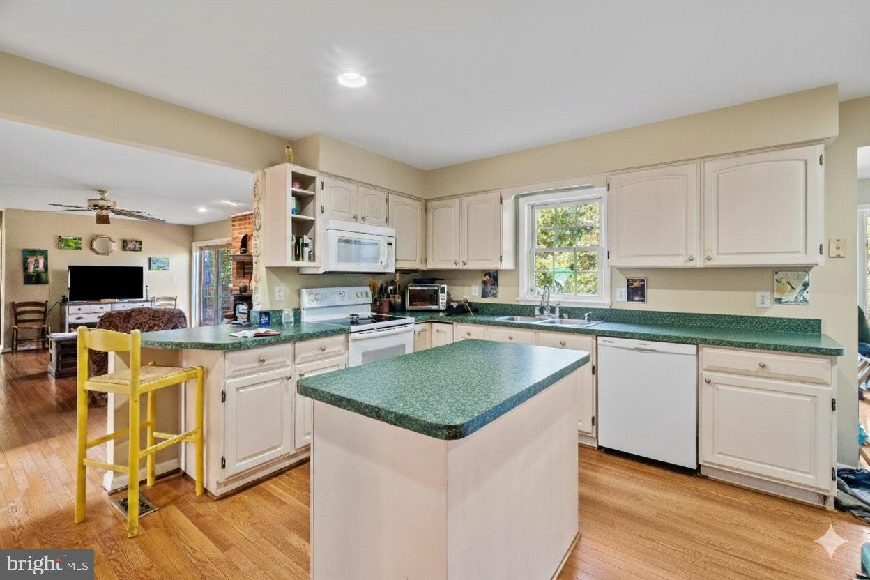 1326 Bernoudy Road White Hall, MD 21161 - Photo 9 of 32 a kitchen with stainless steel appliances granite countertop a stove a sink and a microwave