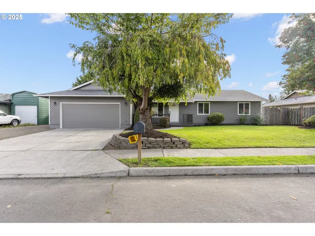 a front view of a house with a garden and yard