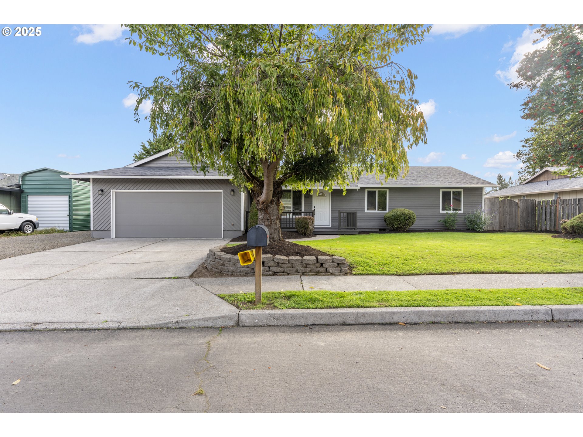 a front view of a house with a garden and yard
