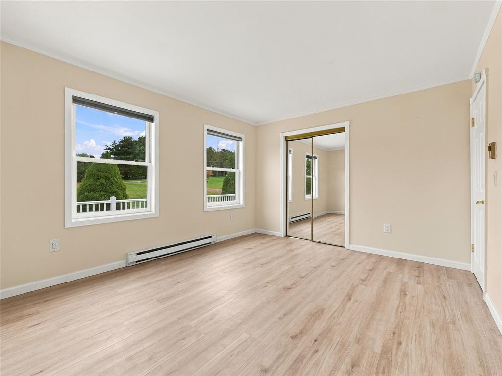 90 Gun Club Road Palmerton, PA 18071 - Photo 38 of 58 Warm wood flooring and mirrored closet doors anchor this sunlit space with garden views.