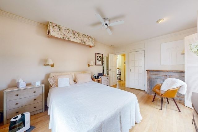 a bedroom with a bed and a chair in it