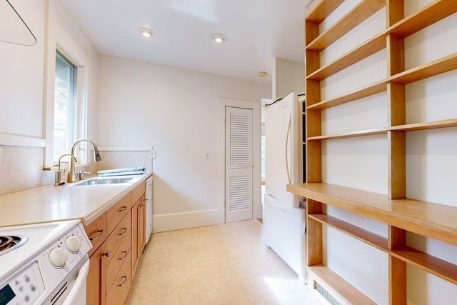 a hallway with a sink and a window
