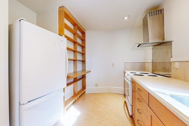 a kitchen with a stove and a refrigerator
