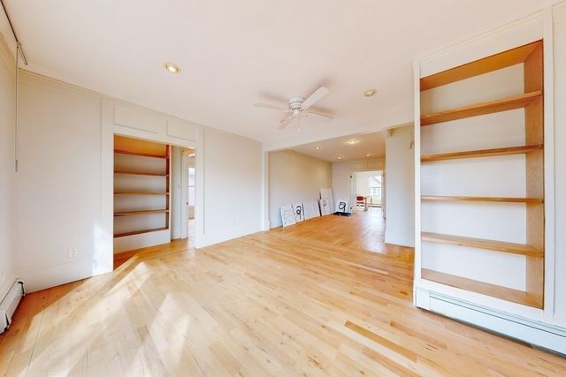 a bedroom with a bed and a ceiling fan