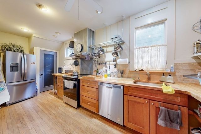 a kitchen with granite countertop a sink appliances cabinets and counter space